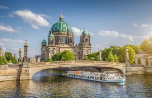 Berlin Cathedral with ship on Spree river at sunset, Berlin Mitte, Germany
